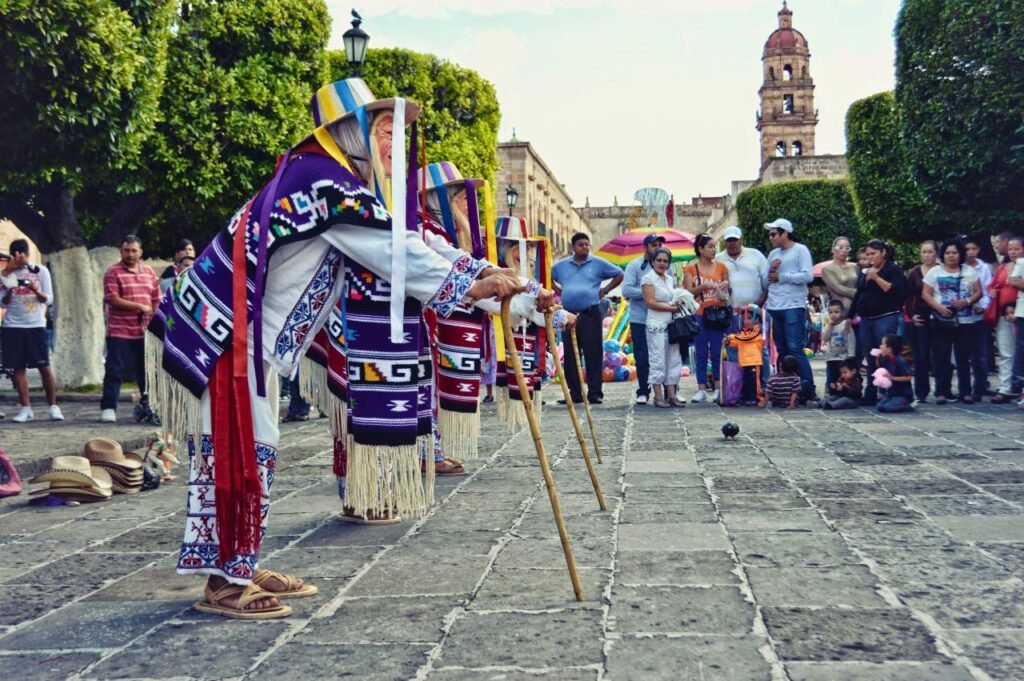 colorful traditional dance performance in city square, showcasing cultural attire and lively atmosphere. morelia, mexico