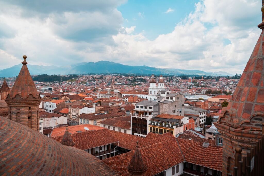 discover the beautiful skyline of cuenca, ecuador, featuring historic architecture and a scenic mountainous backdrop