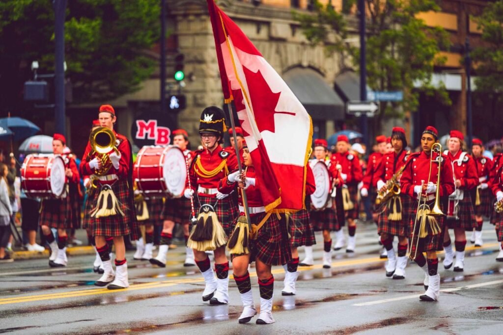festive marching band in victoria, bc, celebrating with canadian flags and colorful costumes victoria, bc, canada