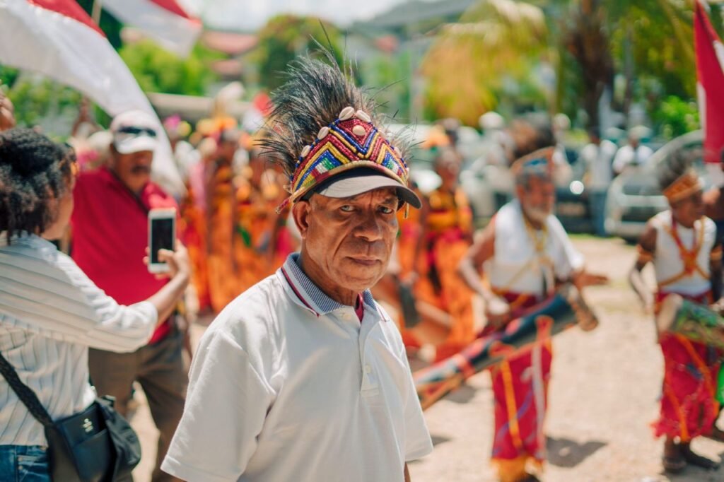 man in traditional attire with vibrant headdress in festive cultural parade