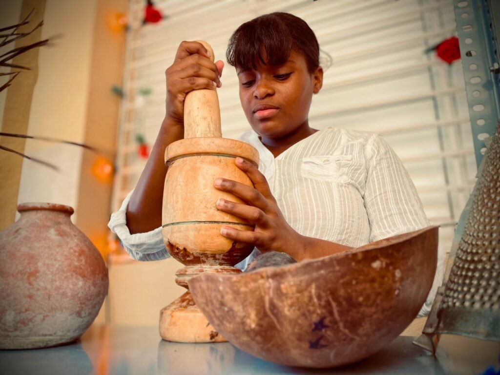 woman using mortar and pestle in rustic dominican setting, emphasizing traditional cooking