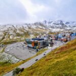 a snow dusted mountain town with parking lot and scenic roads on a clear day. andorra culture