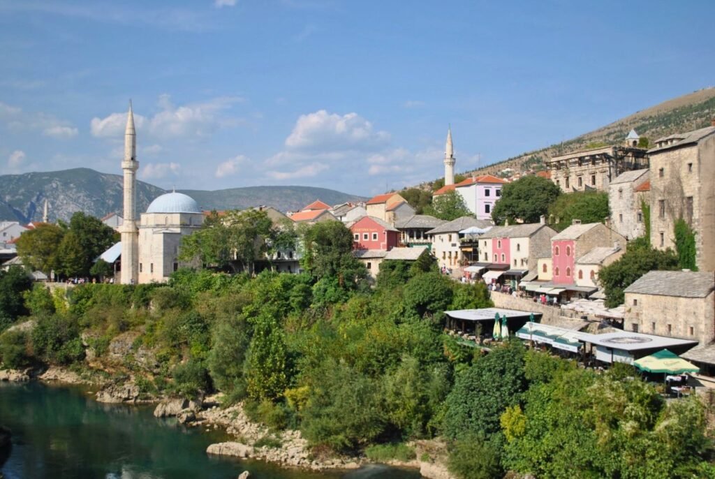 beautiful view of mostar's old town with neretva river and minarets under a blue sky mostar, bosnia and herzegovina