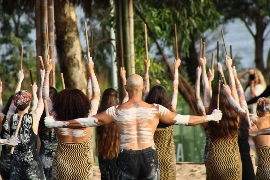 group of dancers in traditional aboriginal attire performing outdoors sydney, australia