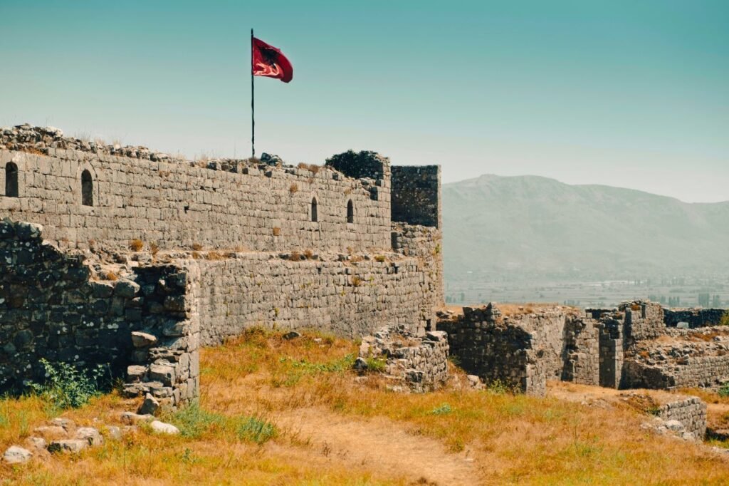 historic shkodra castle ruins with albanian flag, overlooking mountains