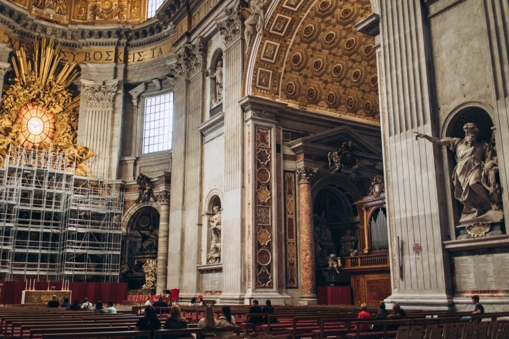 interior view of st. peters basilica showcasing ornate architecture and worshippers vatican city,