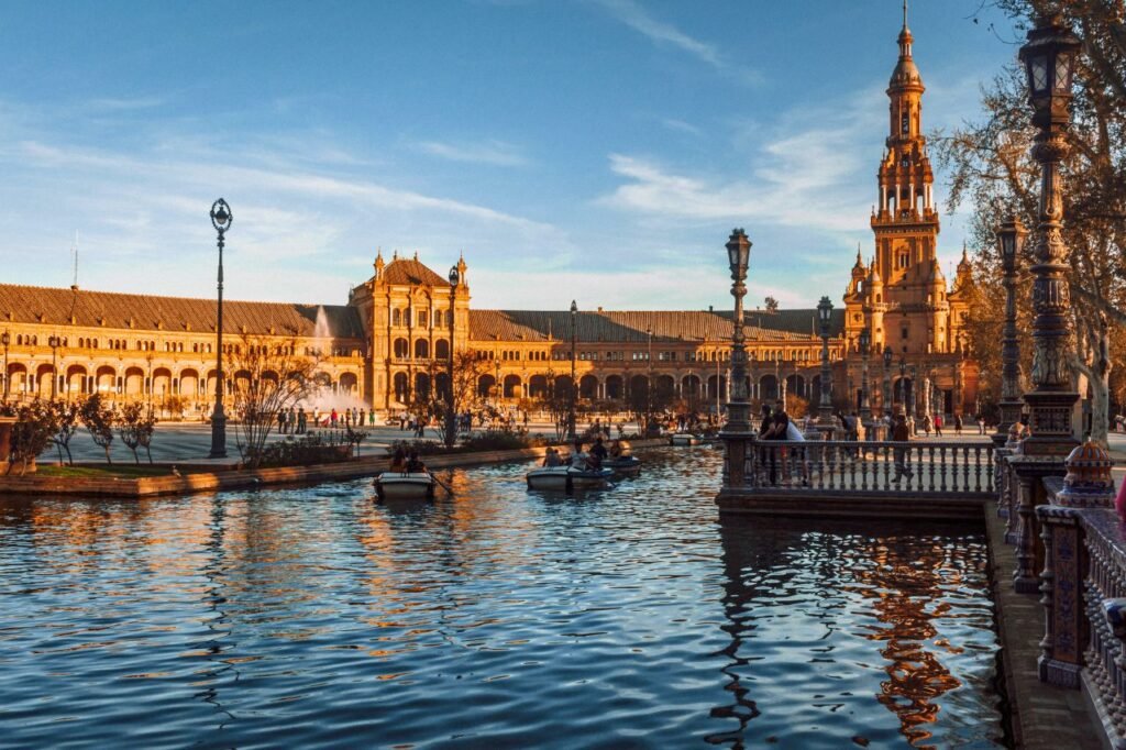 scenic view of plaza de españa in seville with reflections on the canal at sunset spain