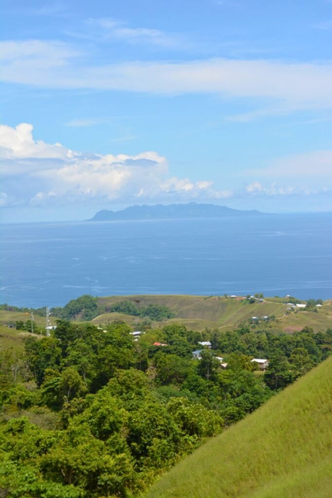 discover the serene beauty of the lush green landscapes meeting the azure sea in the solomon islands