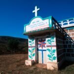 Why Malagasy People Never Point at a Grave With a Finger — and What They Use Instead a colorfully decorated tomb stands in the countryside in madagascar.